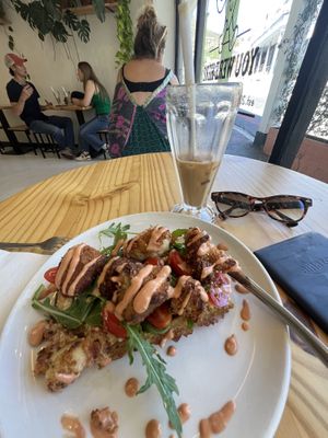 Tasty hash brown and cauli bites waffle with spicy sauce. Delicious iced coffee.  at Grumpy & Runt in Western Cape