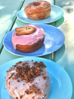 Carrot cake donut, vanilla donut with bunny shortbread cookie, and classic cinnamon sugar donut. at Grumpy & Runt in Western Cape