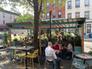 Outdoor dining area at Ras Plant Based in Brooklyn