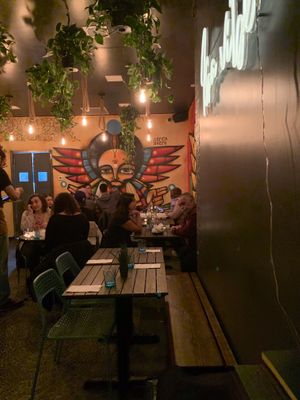 Seating area with beautiful decor and mural paintings at Ras Plant Based in Brooklyn