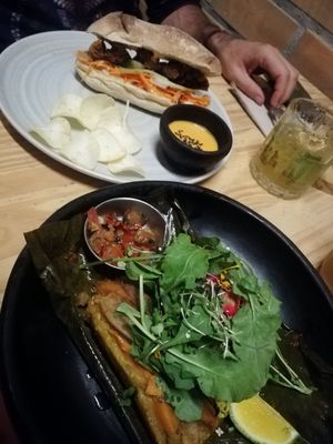 Envuelto criollo and banh mi. The cocktail is with coca aguardiente and maracuya. at INA Restaurante in Medellin