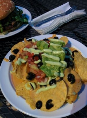 small size nachos: refried beans, some tomatoes, guacamole, black olives, 'cheese' sauce at Garden to Grill in Sacramento