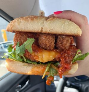 Chicken Parm Sandwich: chicken, mozzarella cheese, spicy arrabiata sauce, mozzarella sticks, arugula, parm  at Peach and Pine in St James