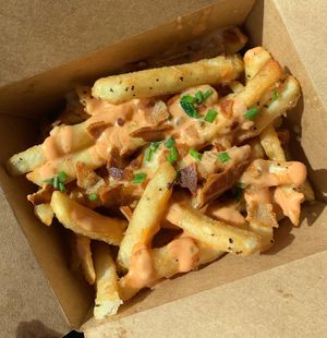 Fancy fries: cheese fries with salt and pepper, chives, bacon, and fancy sauce   at Peach and Pine in St James