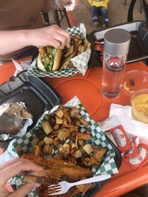 Fish and grits. Sister got the shrimp Po boy.  at Sunshine Vegan Eats in Buffalo