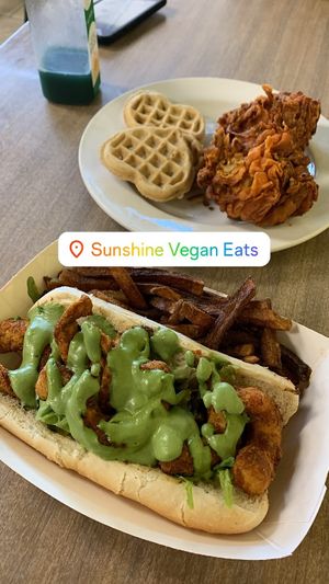 “The Jefferson” shrimp po’boy, chicken and waffles, and “Blu Magic” juice  at Sunshine Vegan Eats in Buffalo