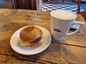Vegan breakfast roll and an oat milk latte at Caffe Nero in Boston