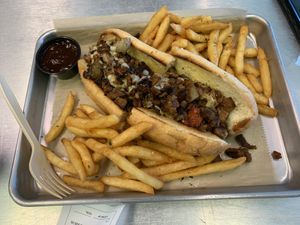 Vegan Philly cheesesteak sandwich with fries  at The Rabbit Hole in Pompano Beach