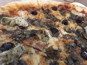 Super Vegan pie with olives, garlicky mushrooms, artichokes, vegan mozzarella and vegan Parmesan  at Homeslice Pizza - Julu Rd in Shanghai