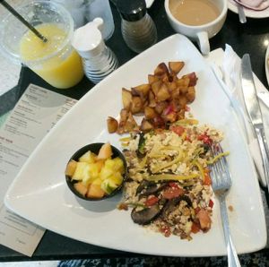 breakfast - tofu scramble with mushrooms, peppers and tomatoes, baked potatoes, toasts and fruits  at The Cafe at Books and Books in Miami Beach