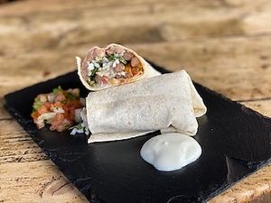 Meatless Burrito with lime and cilantro flavored rice, stir-fried peppers and onions, black beans, refried beans, chipotle sauce and sour cream. 

It can be made vegan upon reque at Cactus Jack in Nyon