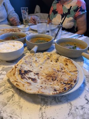 Naan (tarka dhal and mushroom korma in the background )  at Mango Vegetarian in Wetherby