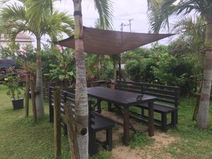 Lovely backyard seating area with sandbox for kids and a beautiful view of surrounding fields at Hikari Rakuen in Ishigaki