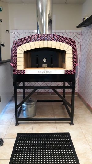 Our 80's inspired custom built wood fire oven with hot pink grout. 😍❤🤙🏾 at Pizza Riot in Chico