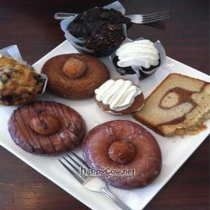vegan chocolate muffin @ top, vegan cinnamon donuts w donut hole in middle, small Fritz vanilla and chocolate vegan cupcakes. at Fritz Pastry in Chicago