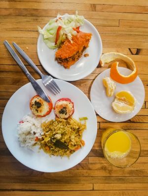 The typically Portuguese "Legumes à Brás" / Stuffed tomatoes / "Empadão" or sweet potato pie with soy and veggie "alheira" stuffing at Impact House in Lisbon