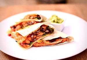 Quesadilla with sweat potatoes, beans and plant based cheddar served with guacamole. One of vegan offers from weekly changing lunch menu.  at The Street  in Prague
