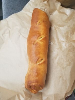 Pepperoni roll served with marinara sauce at Planted Bakery in Fort Worth