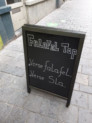 sign on pavement at Falafel Top in Leuven