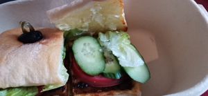 No carrots or cabbage. Just six slices of cucumber and 2 slices of tomato. Very thin tempeh patty.  at Green Friday in Shanghai