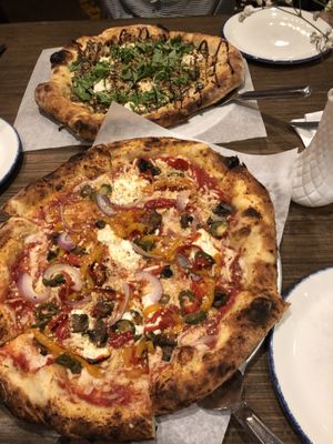 Build your own (near pizza) and Vegan Artichoke Pizza from the menu (far pizza) at The Hall's Pizza Kitchen in Oklahoma City