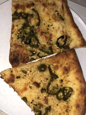 Build your own pizza with garlic sauce, cheeses, and jalapeños at The Hall's Pizza Kitchen in Oklahoma City