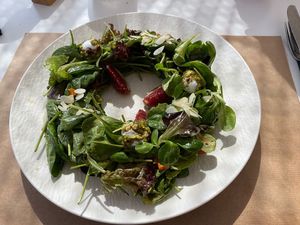 Green Koukoumi Salad with cheese bites dipped in caramelized pistachio nuts, grilled sweet potato, figs and almond flakes in lime vinaigrette. at Koukoumi Hotel in Mykonos