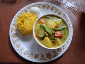 Curry bowl with turmeric rice and egg at Chia Eatery in Dumaguete