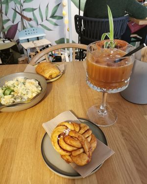 Potato salad on the left and cinnamon bun w iced coffee in the front at Kringel in Tallinn