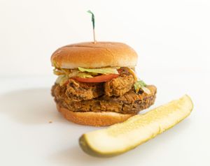 Spicy Bae: Double battered portabello mushrooms, lettuce, tomatoes, and Que Dabra sauce are stuffed into a warm bun.  at Plant Bae in Montgomery