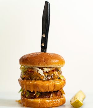 The Big Malc: The Sydney Bae patty (our in-house sweet potato and oats patty), Beyond Meat patty, double vegan cheese, lettuce, tomatoes, sautéd onions, and our special Que Dabra  at Plant Bae in Montgomery