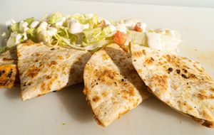 E's Que-Sadilla: Beefless crumbles, vegan cheddar cheese, and our sweet and smoky Que Dabra sauce are toasted in tortilla shells. Served with lettuce, tomatoes, and vegan ranch dre at Plant Bae in Montgomery