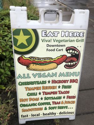Sign in front of parking lot  at Viva! Vegetarian Grill - Food Cart in Eugene