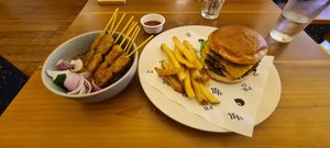 Chicken skewers in satay sauce; love handle OG burger with skin-on fries at Love Handle in Central Singapore