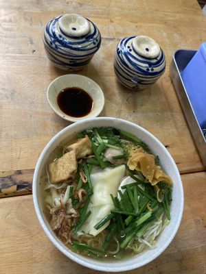 Dumpling noodle soup, comes with some condiments: sauce, spicy flakes and limes  at Nuoc Leo Chay in Ho Chi Minh City
