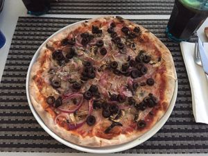 Vegan pizza with mushrooms, onion, olives and vegan cheese at La Pizza in Tavira