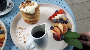Pancakes with syrup on the side. at Greenfinch in Berlin