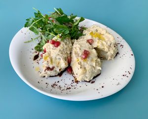 Mutabal: Grilled eggplant with tahini, garlic, lemon, and topped with pomegranate molasses and pomegranate seeds.  at Muito BEY in Lisbon