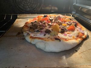 Dough ball in the oven! (with lots of veggies + Miyoko’s mozzarella) 🍕  at Aver's Pizza in Bloomington