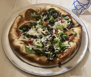 Vegan cheese & pepperoni with spinach, sundried tomatoes, onions, broccoli, basill  at Pretzel & Pizza Creations in Frederick