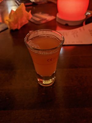 Complementary non-alcoholic citrus shot after the dinner. at Aastha in Berlin