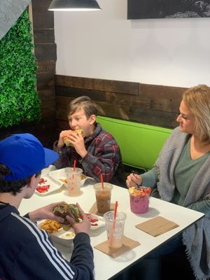 Family Enjoying a vegan meal together. at Daily Veg in Newark
