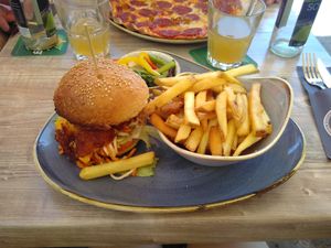 Weekly menu. Asian inspired burger wih fries and salad at Restaurant Aal Eechternoach in Echternach