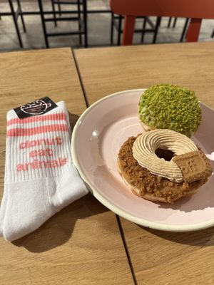 Lotus donut, pistachio donut and Brammibal's merch socks!   at Brammibal's Donuts - Friedrichshain in Berlin