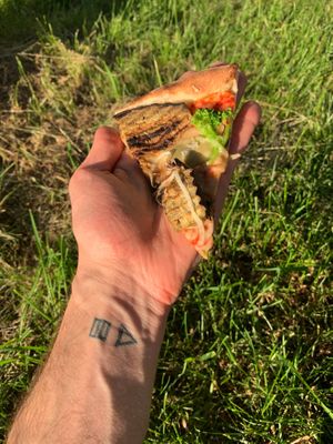 A slice of the verdura pizza (vegan cheese, tomato sauce, eggplant, broccoli, fresh mushrooms, artichokes, onions) at Pizza Huus in Bern