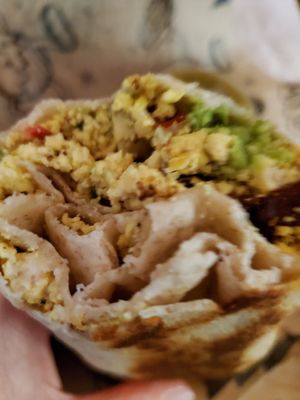 The happy cow burrito has marinated tofu, potatoes, avocado, and incredible house made Pico de gallo. The burrito is grilled after assembly. at Rise Up Coffee in Ocean City