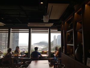 View of Aberdeen Harbour, Jumbo and boats. African patterned cushions and decor at Africa Coffee & Tea in Hong Kong Island