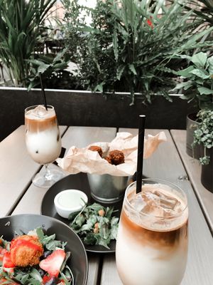 Iced latte with coconut milk, sweet tofu salad with strawberries, blueberries and strawberry sauce (it really tasted like sweet curd), garlic sauce, mashed mushroom “balls”, sa at Kozy Eats  in Riga