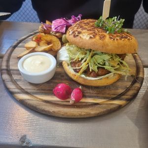 Soya power burger with wedges and salad at Kozy Eats  in Riga