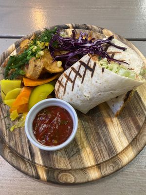 Burrito with pb mince, wedges, salad, pickles at Kozy Eats  in Riga